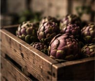 A wooden crate of purple artichokes