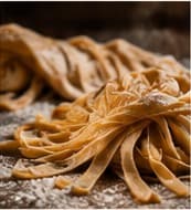 Fresh tagliatelle on a floured board