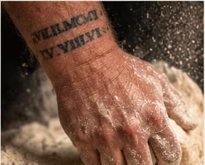 A floured hand kneading dough