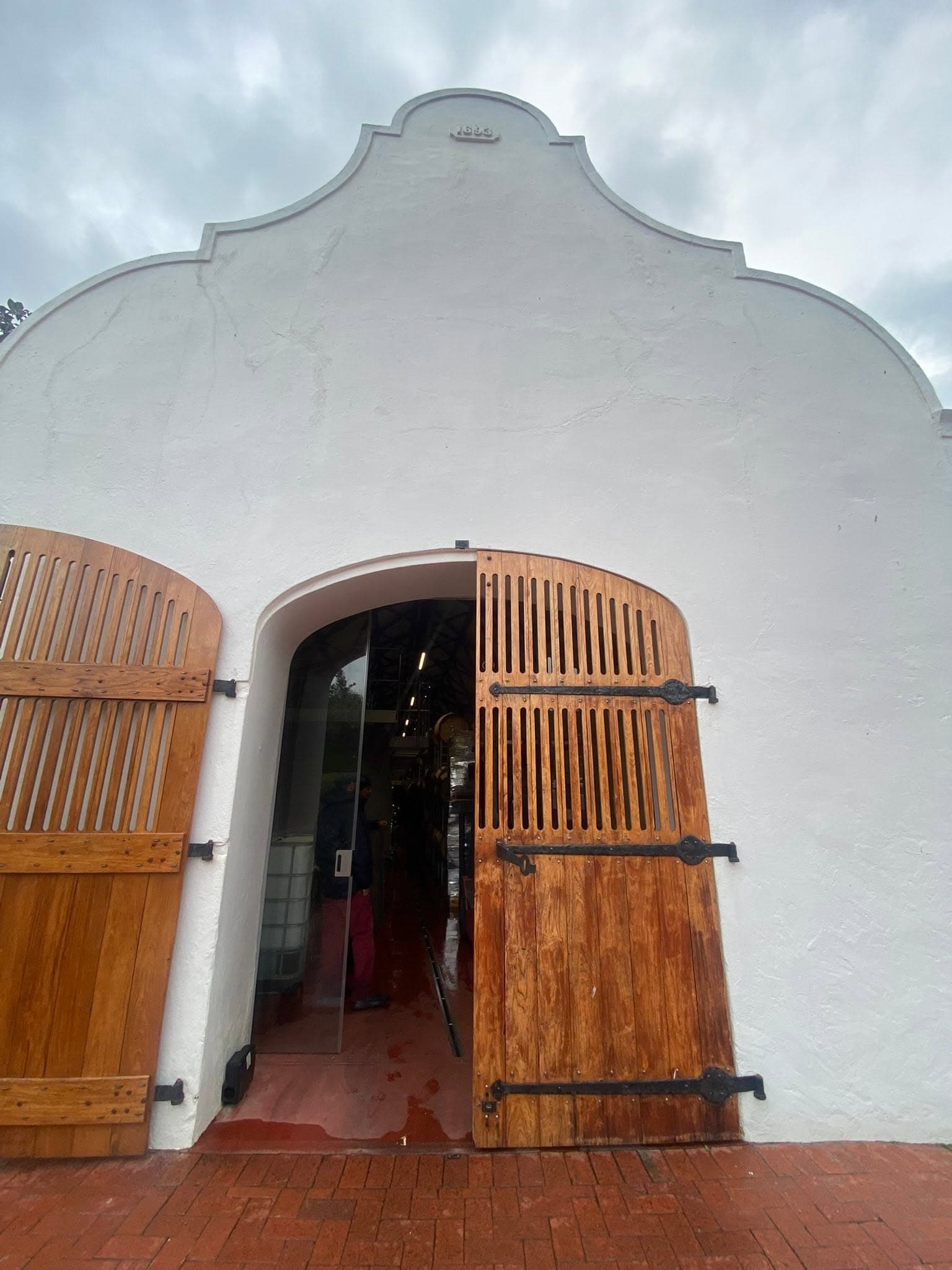 The open timber door of a whitewashed cellar
