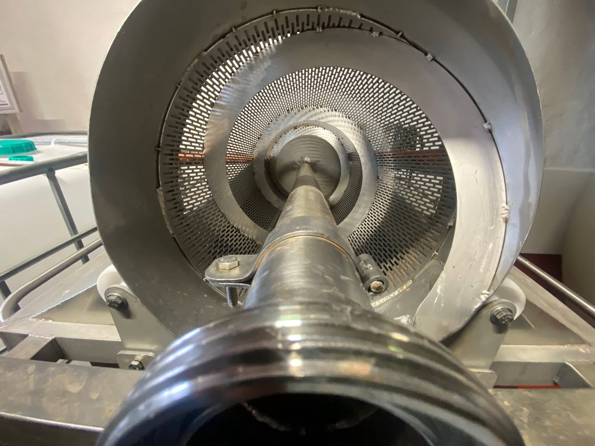 The steel basket of a wine press in the cellar