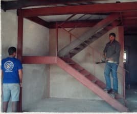 The red steel stair and mezzanine under construction