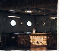 The bar and portholes, lit for the evening