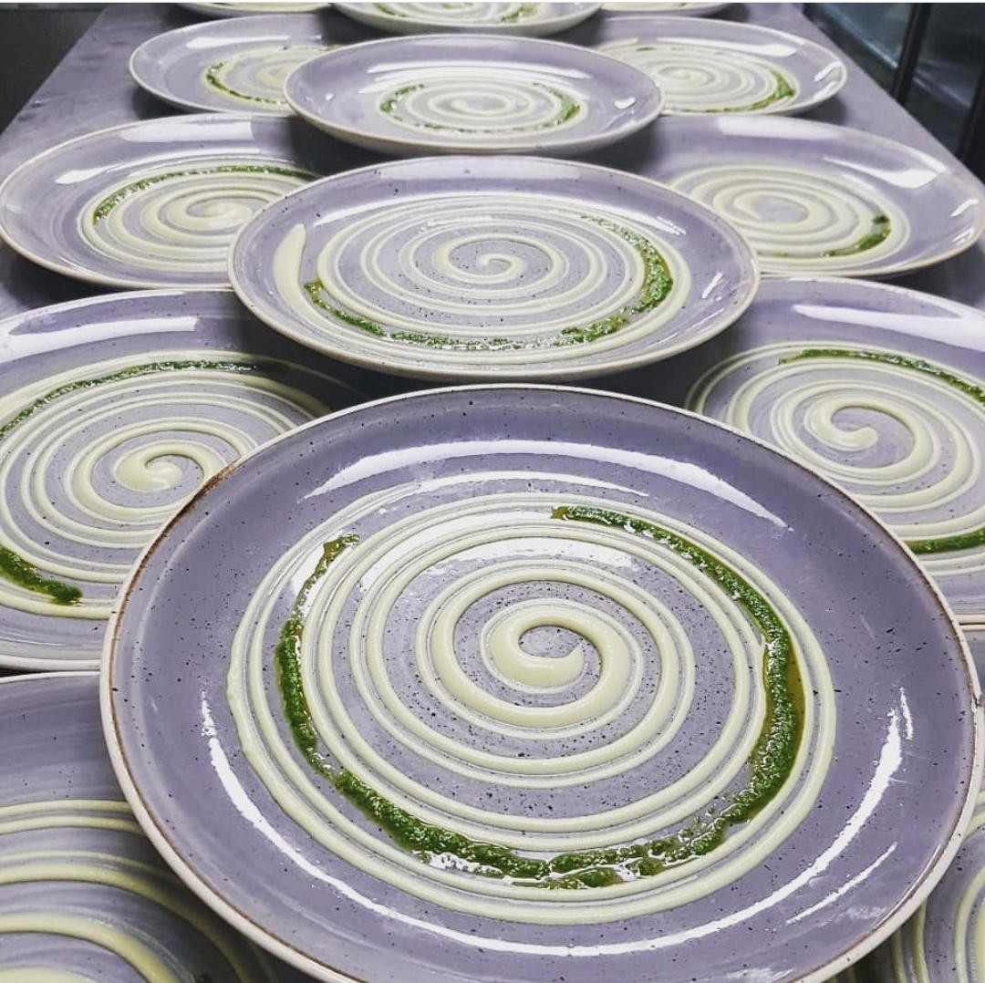Purple plates prepared in repeating spirals before service
